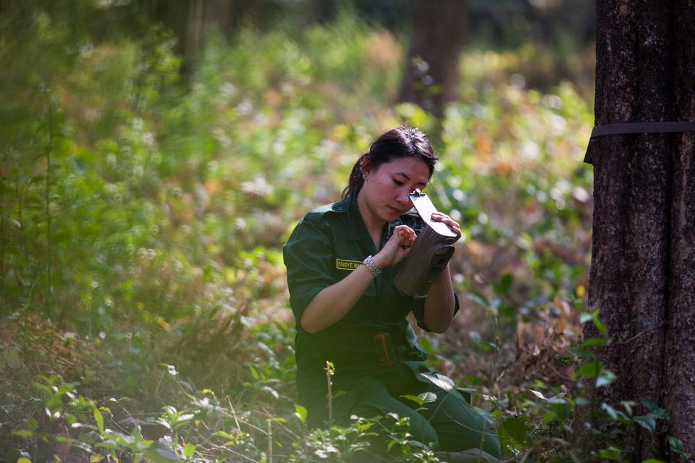 Singye installs a camera trap to monitor tigers.