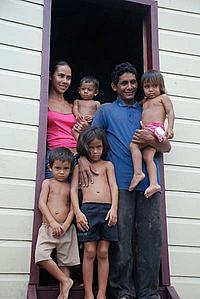 Dona Maria and family on the steps of their new home - © Damian Fleming / WWF-UK Dona Maria and family on the steps of their new home