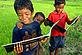 Three Khmer boys reading fish conservation book © WWF-Canon / Zeb HOGAN