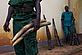 Ranger holding seized ivory with seized guns in background, outside WWF office in Yokadouma, East province, Cameroon