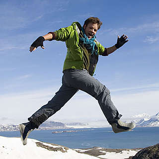 UK Ambassador for Change, Casper ter Kuile, jumping over rocks in Spitsbergen, Norway - © Sindre Kinnerod / WWF-Canon UK Ambassador for Change, Casper ter Kuile, jumping over rocks in Spitsbergen, Norway