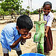 Children using a newly built water pump in the village of Karikkattukuppam in India, Asia
