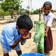 Children using a newly built water pump in the village of Karikkattukuppam in India, Asia