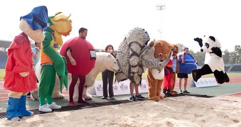 Panda in long jump at mascot competition