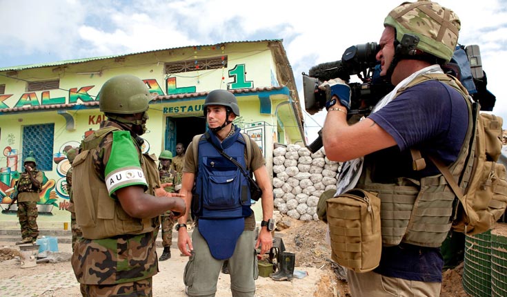Jonathan Young, cameraman (right) and Simon Reeve (centre), with Ugandan peacekeeping troops on the frontline in Mogadishu, Somalia © Andrew Carter Jonathan Young, cameraman (right) and Simon Reeve (centre), with Ugandan peacekeeping troops on the frontline in Mogadishu, Somalia © Andrew Carter