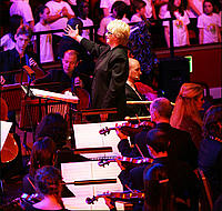 Orchestra and conductor from One Sun One World premiere