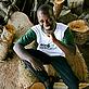 Alex Kubi sitting amongst a pile of FSC coded logs, Akamba Handicrafts, Kenya - © Brent Stirton / Getty Images Alex Kubi sitting amongst a pile of FSC coded logs, Akamba Handicrafts, Kenya