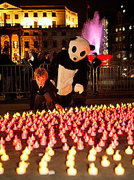Panda and schoolboy help move 'sand' in hourglass at Trafalgar Square Earth Hour 2010