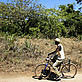 A man cycles through the Kaya Waa sacred forest - © Brent Stirton / Getty Images / WWF-UK A man cycles through the Kaya Waa sacred forest