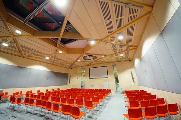 After testing with a 3D model, extra fabric-covered acoustic panels were added to the side walls of the auditorium to improve sound quality